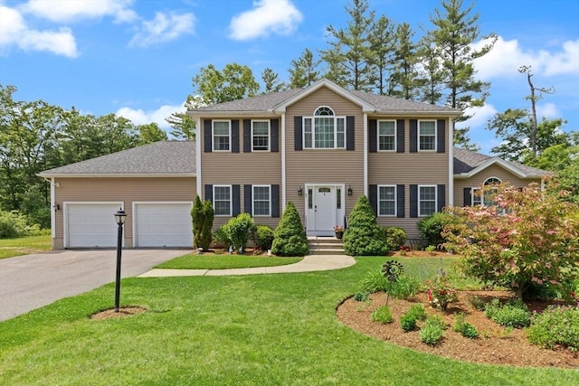 1 Windsor Rd, Shirley, MA 01464 - colonial house with asphalt driveway, a garage, a front lawn, and roof with shingles