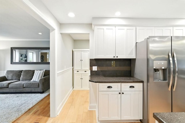 3 Pine Knl, Southwick, MA 01077 - kitchen featuring stainless steel fridge, light wood-style floors, white cabinets, tasteful backsplash, and dark stone counters