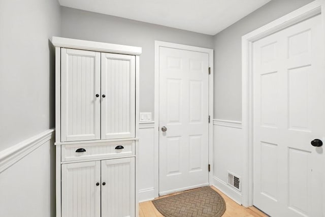 3 Pine Knl, Southwick, MA 01077 - doorway to outside with light wood-style flooring and wainscoting