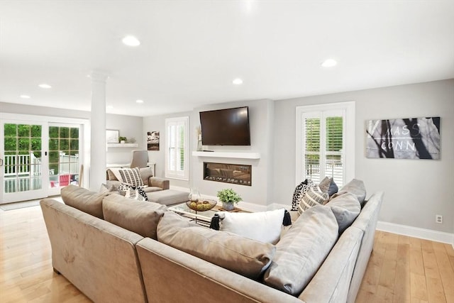 3 Pine Knl, Southwick, MA 01077 - living room with light wood-style flooring, recessed lighting, baseboards, a glass covered fireplace, and decorative columns