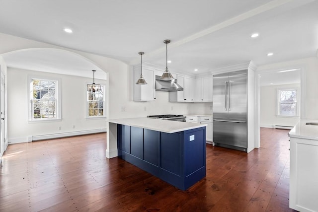 6 Parker Ave, Cohasset, MA 02025 - kitchen featuring stainless steel built in refrigerator, baseboard heating, a peninsula, wall chimney range hood, and light countertops