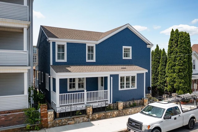 247 Pitman St, Fall River, MA 02723 - view of front facade featuring a shingled roof, covered porch, and a fenced front yard