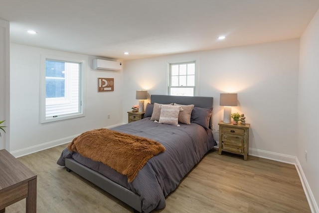 247 Pitman St, Fall River, MA 02723 - bedroom with an AC wall unit, light wood finished floors, baseboards, and recessed lighting