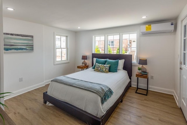 247 Pitman St, Fall River, MA 02723 - bedroom featuring an AC wall unit, wood finished floors, baseboards, and recessed lighting