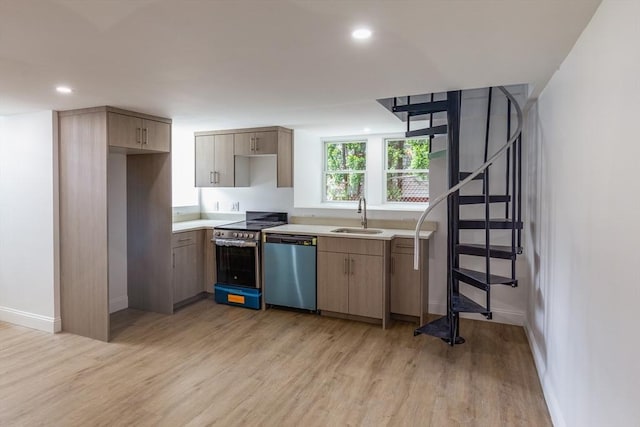247 Pitman St, Fall River, MA 02723 - kitchen with stainless steel appliances, a sink, light wood finished floors, light countertops, and baseboards