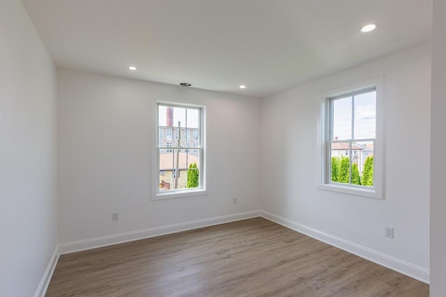 247 Pitman St, Fall River, MA 02723 - empty room with wood finished floors, baseboards, and recessed lighting