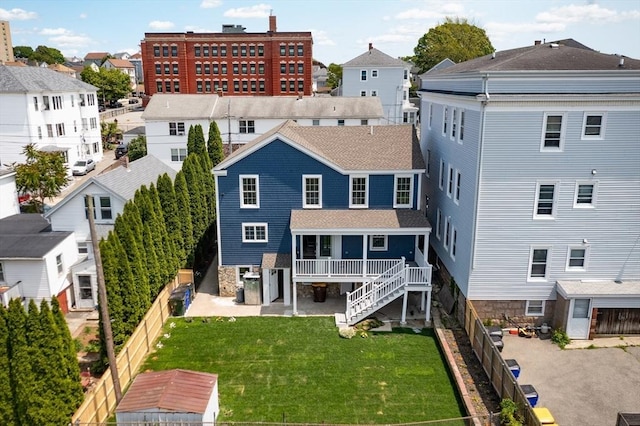 247 Pitman St, Fall River, MA 02723 - back of property with a patio area, a shingled roof, and a residential view