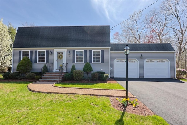 cape cod-style house with an attached garage, a front lawn, aphalt driveway, and roof with shingles