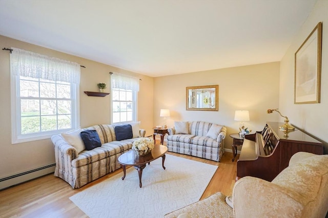 living room featuring a baseboard heating unit and wood finished floors