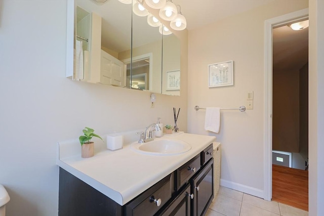 bathroom with tile patterned floors, baseboards, and vanity