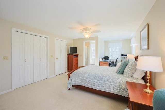 bedroom with a ceiling fan, baseboards, and light colored carpet