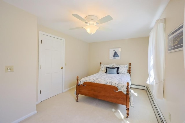 bedroom with baseboards, ceiling fan, a baseboard heating unit, and light carpet