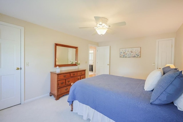 bedroom with light colored carpet, baseboards, and ceiling fan