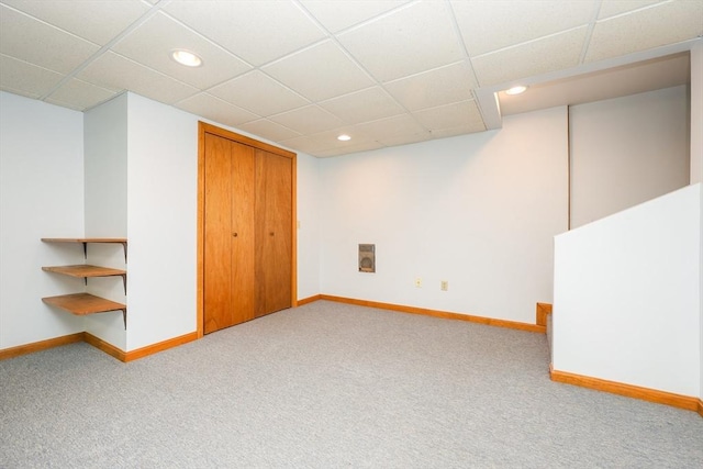 finished below grade area with recessed lighting, carpet flooring, a paneled ceiling, and baseboards