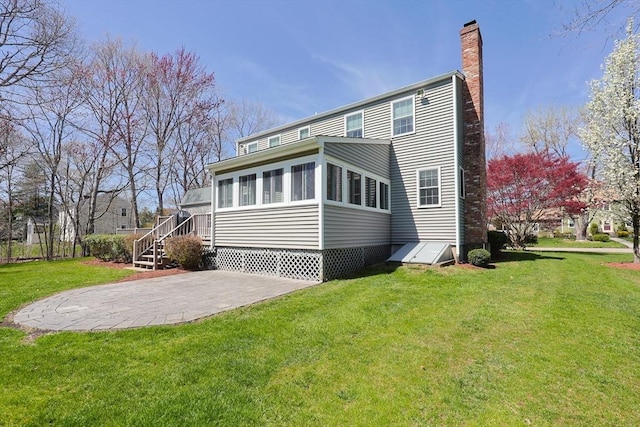 back of property featuring a yard and a chimney