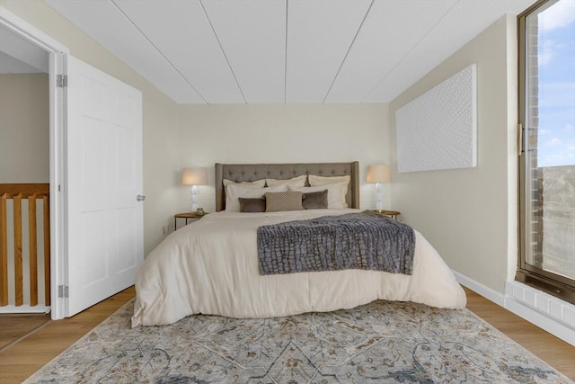 bedroom featuring hardwood / wood-style floors and multiple windows