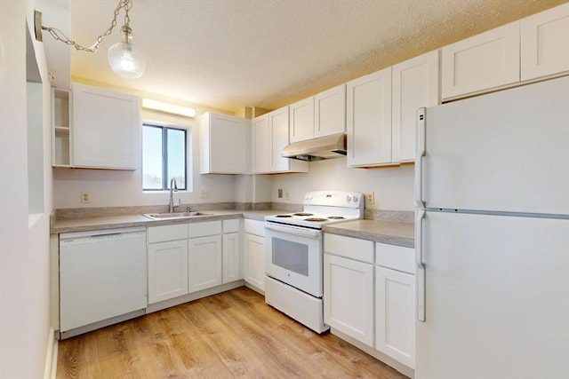 47 Mystic St Unit 4E, Arlington, MA 02474 - kitchen featuring white appliances, under cabinet range hood, a sink, white cabinetry, and light countertops