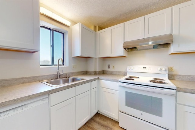 47 Mystic St Unit 4E, Arlington, MA 02474 - kitchen with white appliances, under cabinet range hood, a sink, white cabinetry, and light countertops