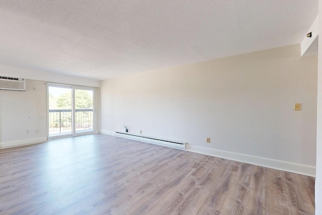 47 Mystic St Unit 4E, Arlington, MA 02474 - unfurnished room with baseboard heating, wood finished floors, a textured ceiling, and baseboards