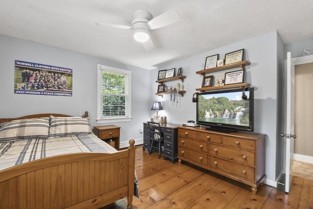 bedroom featuring baseboards, a ceiling fan, and hardwood / wood-style flooring