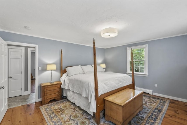 bedroom with wood-type flooring, baseboards, and ornamental molding
