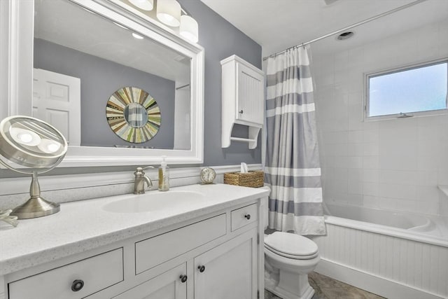full bath featuring shower / bath combination with curtain, vanity, and toilet