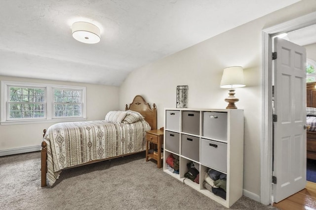 carpeted bedroom with a baseboard radiator, lofted ceiling, and baseboards