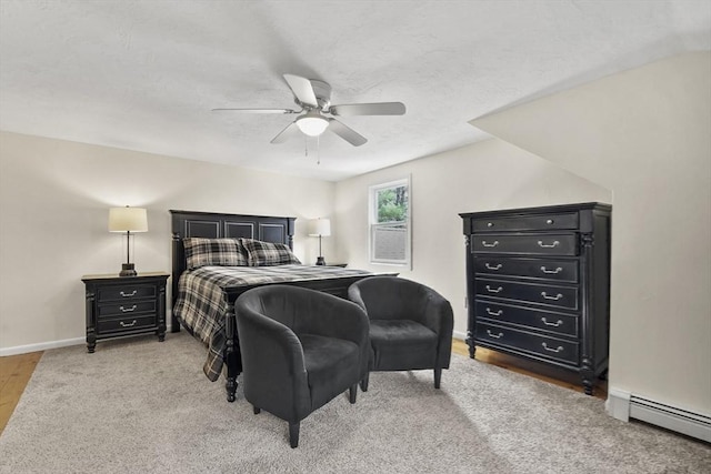 bedroom with a baseboard radiator, baseboards, and a ceiling fan