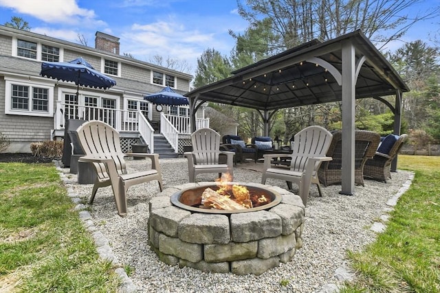view of patio featuring a fire pit and a gazebo