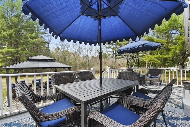 deck featuring a gazebo and outdoor dining space