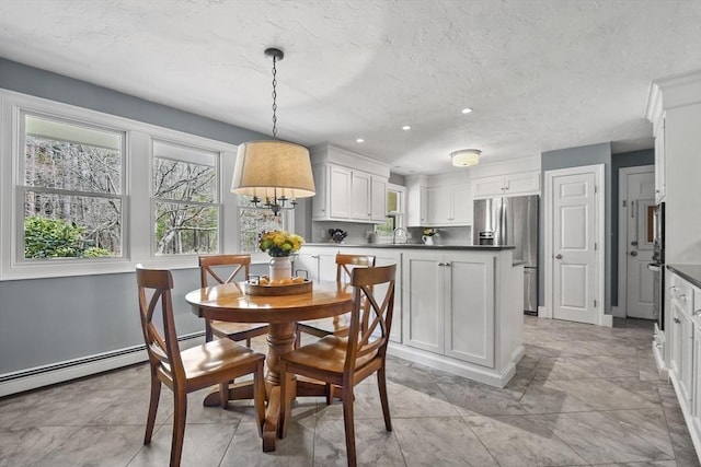 dining room featuring a textured ceiling and recessed lighting