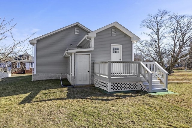 rear view of property with a yard