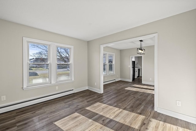 interior space featuring baseboard heating and dark wood-type flooring