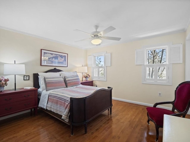 bedroom with a ceiling fan, crown molding, wood finished floors, and baseboards