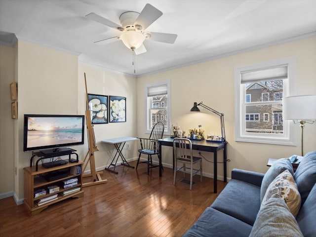 living area featuring ceiling fan, crown molding, baseboards, and wood finished floors