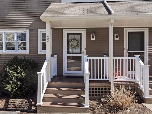 property entrance featuring a porch and a shingled roof