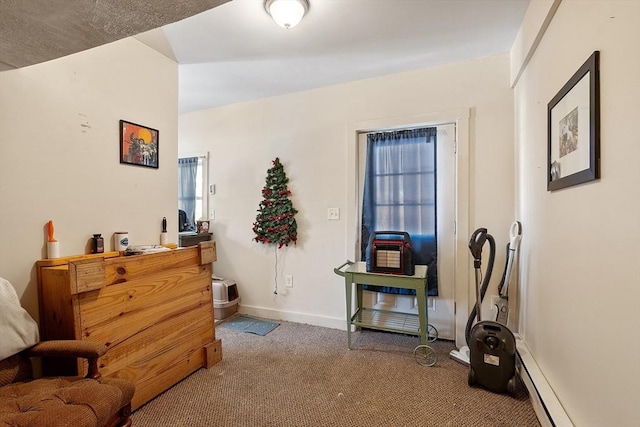 sitting room with a baseboard radiator and carpet