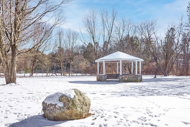 yard covered in snow with a gazebo