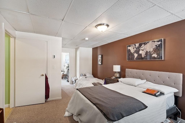 carpeted bedroom featuring a paneled ceiling