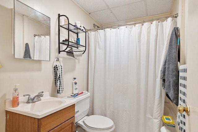 bathroom with a paneled ceiling, vanity, toilet, and a shower with shower curtain