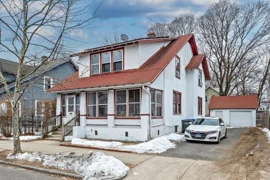 90 Rochelle St, Springfield, MA 01109 - view of front facade with aphalt driveway, crawl space, an outdoor structure, and a detached garage