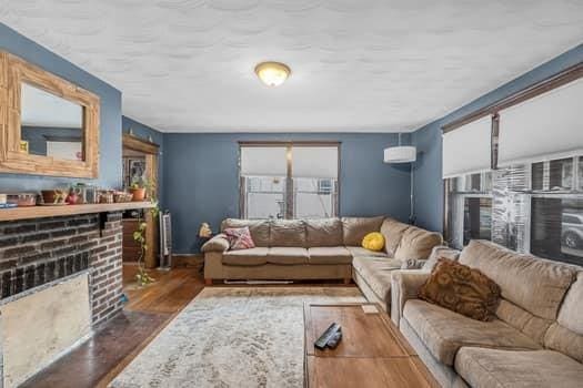 90 Rochelle St, Springfield, MA 01109 - living room with a brick fireplace and wood finished floors