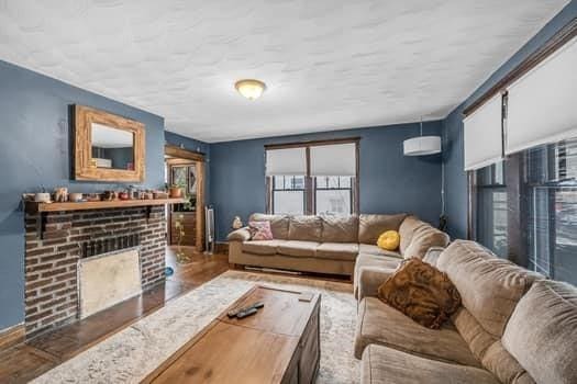 90 Rochelle St, Springfield, MA 01109 - living room with wood finished floors and a fireplace