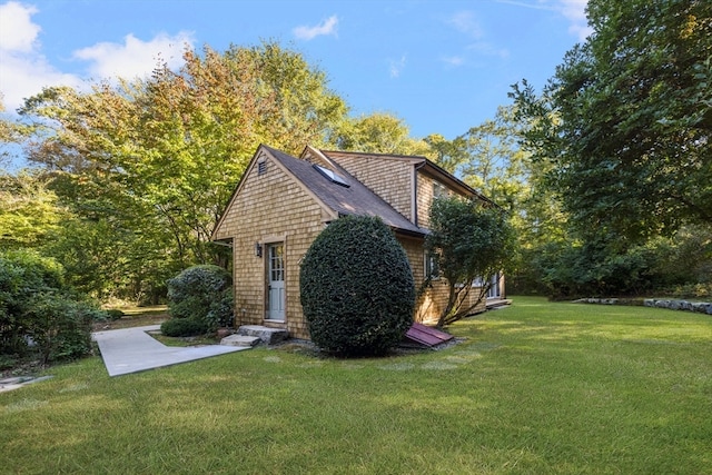 view of side of home featuring a lawn