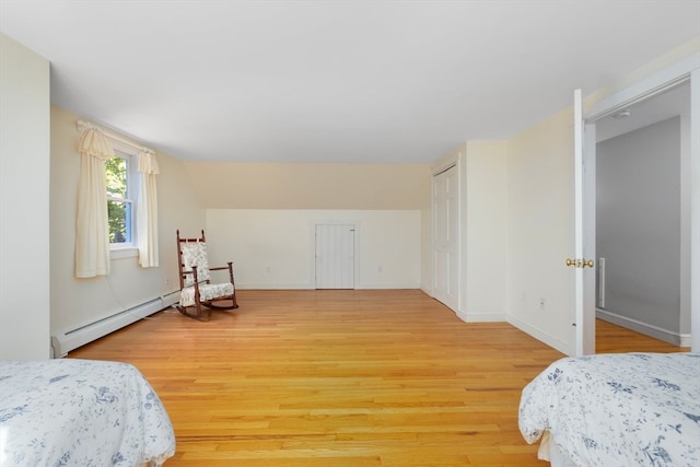 bedroom featuring a baseboard radiator and wood-type flooring