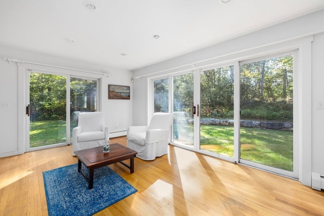 sunroom featuring baseboard heating and plenty of natural light