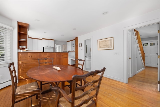 dining area with light hardwood / wood-style floors