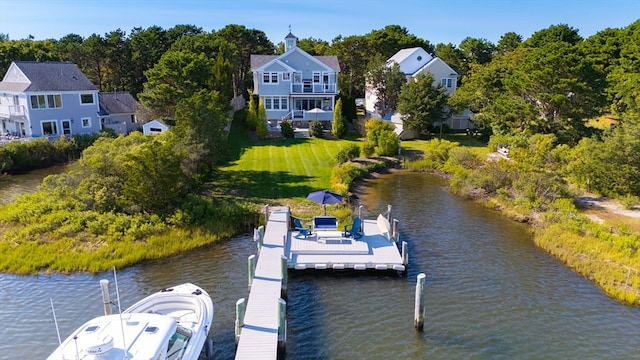 dock area featuring a lawn and a water view