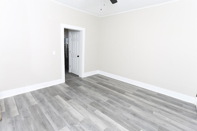 unfurnished room featuring crown molding, ceiling fan, and light wood-type flooring