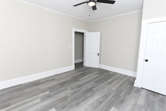 unfurnished bedroom featuring crown molding, light hardwood / wood-style floors, a closet, and ceiling fan